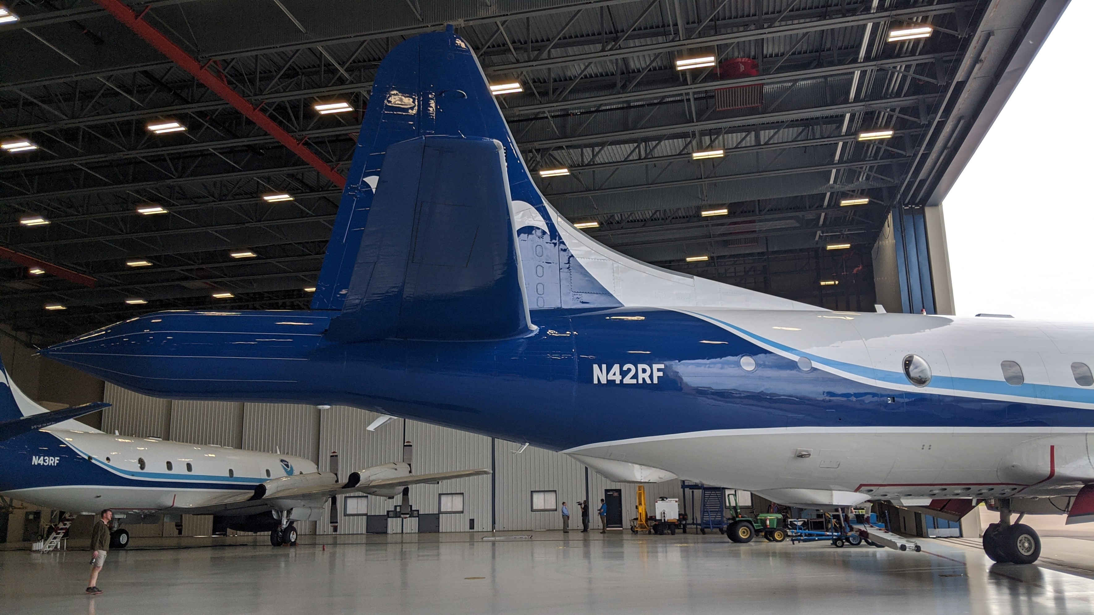 NOAA plane backing into hangar