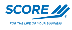 A Logo for SCORE. The logo contains the word SCORE in all caps, with three lines to the right of the word and partially underlining it. Underneath the whole logo is the phrase "For the life of your business."