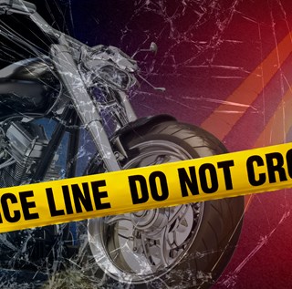 A photo of a motorcycle with police caution tape across the front