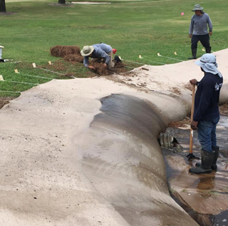 lakeshore utilizing dredgesox to stabilize shoreline with workers