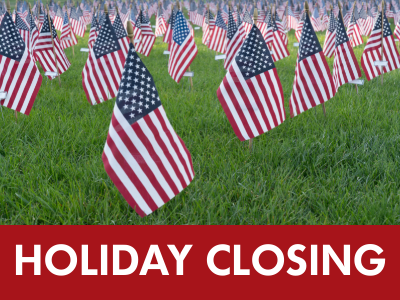 Field of grass with rows of small American flags stuck in the grass and text Holiday Closing