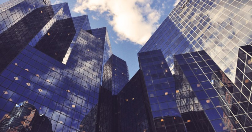 Skyscraper buildings reflecting the blue sky above them