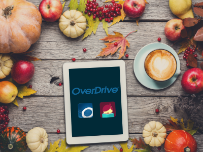 Pumpkins, apples, and latte surrounding ereader tablet with OverDrive logo and OverDrive/Libby apps on screen link to OverDrive digital collection