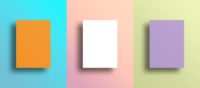 three blank canvases on three different colored squares of wall