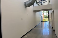 Arts & Rec Exhibit Space at the Lake Crago Outdoor Recreation Complex Rec building. This exhibit space is located in a hallway behind the main check-in space. Guests utilize this space en route to two educational classrooms/meeting spaces.