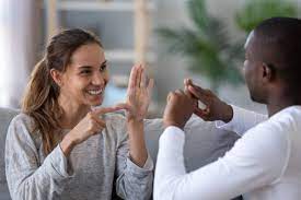 woman and man using sign language