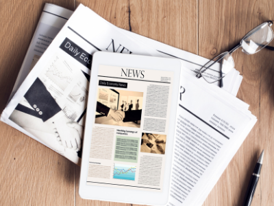 Newspaper with tablet device on top, screen of tablet shows same image and text News as newspaper