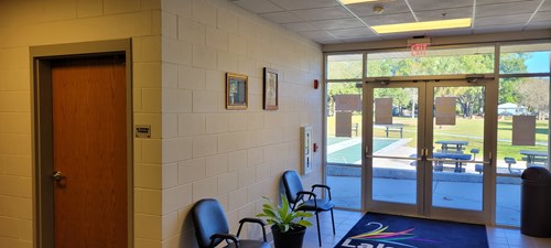 view of hallway with glass door to the outside in the background