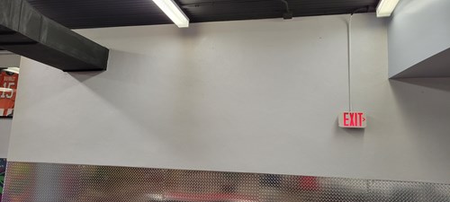 Blank wall with exit sign  on it