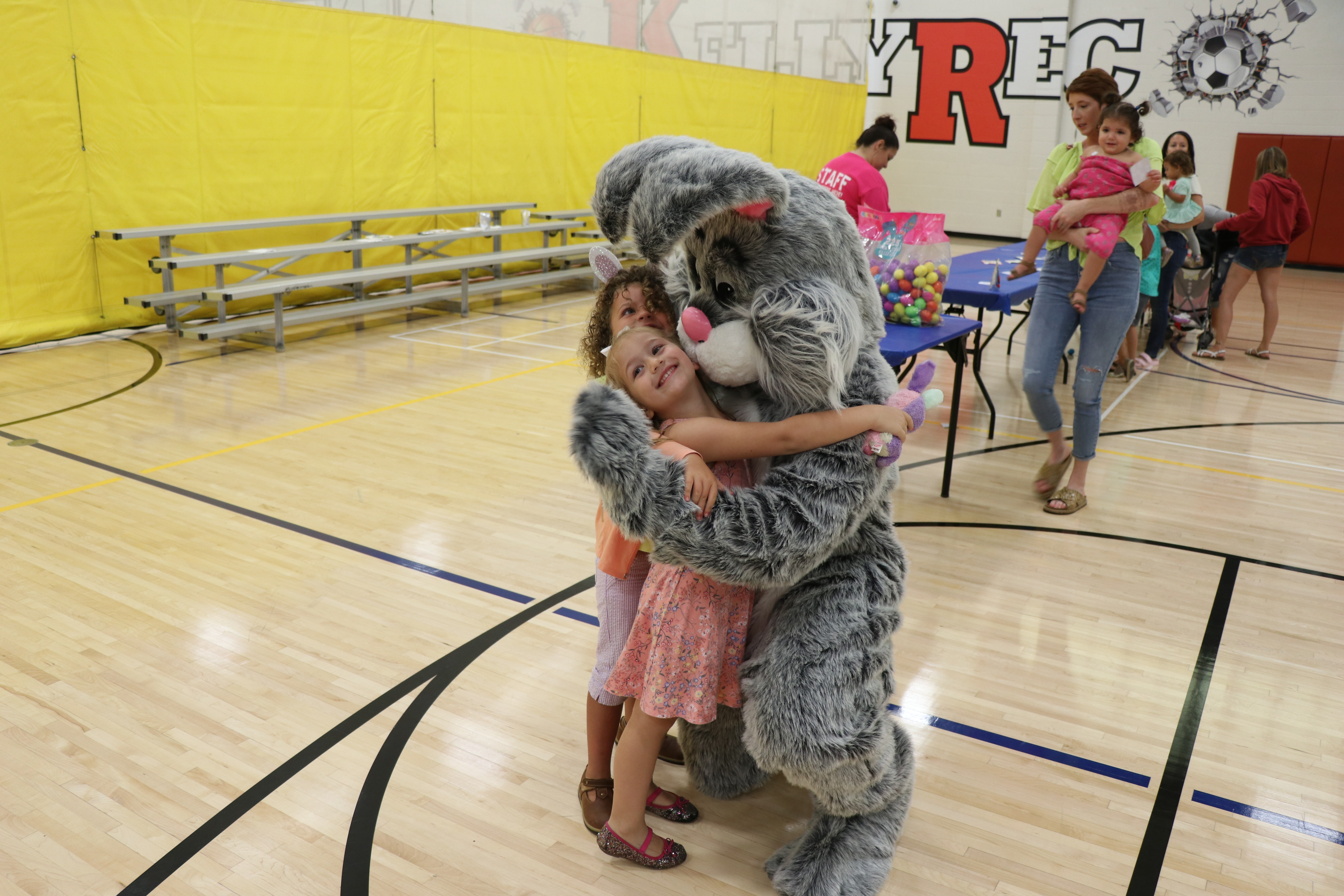 Small child hugging the Easter Bunny in the Kelly Recreation Complex Gym