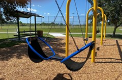 John McGee Park with swings including accessible pieces in the foreground