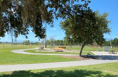 John McGee Park with a walking path in the foreground and soccer fields in the background.