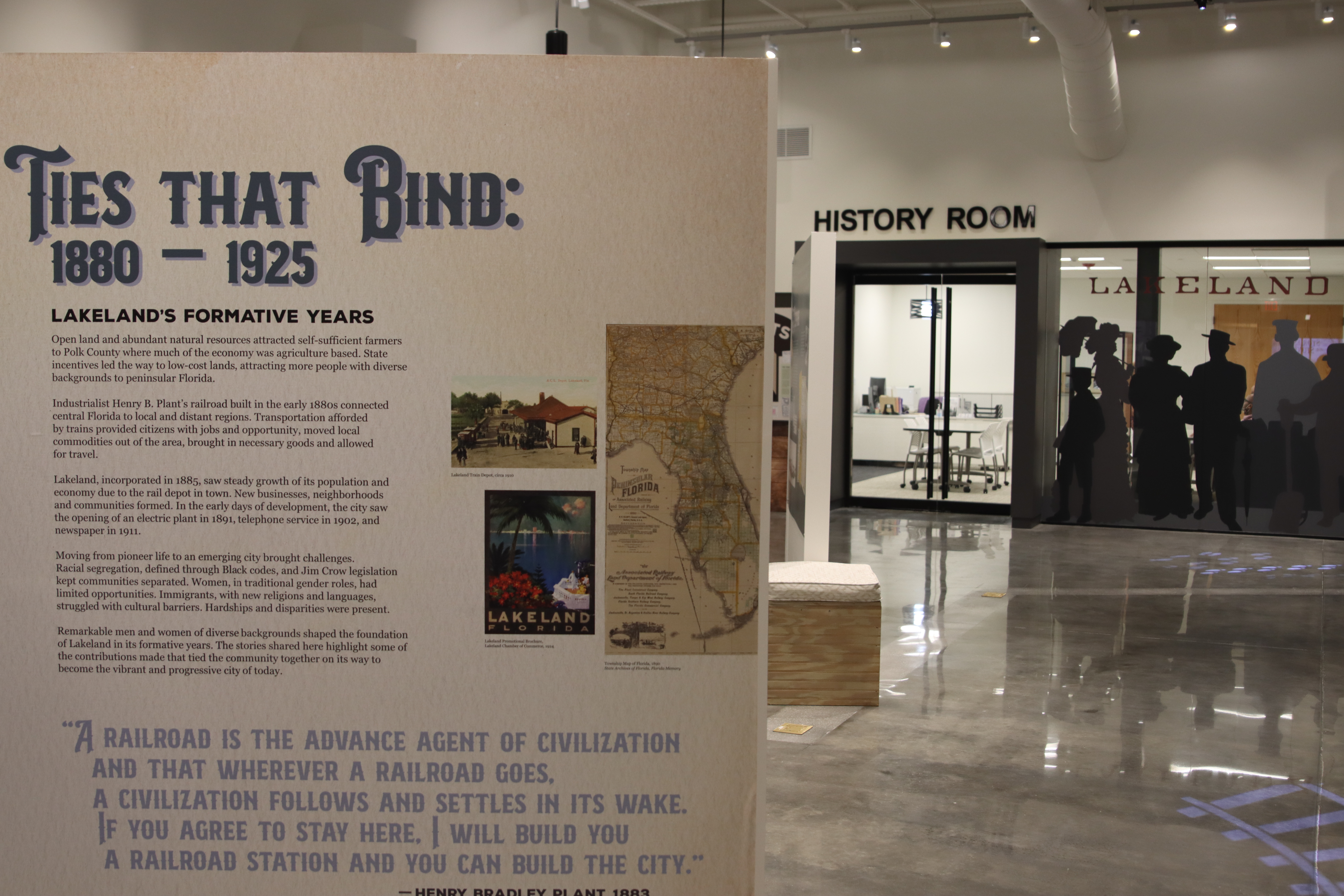 View into Lakeland History and Culture Center exhibit with "Ties that Bind" information panel in foreground and "History Room" door in background