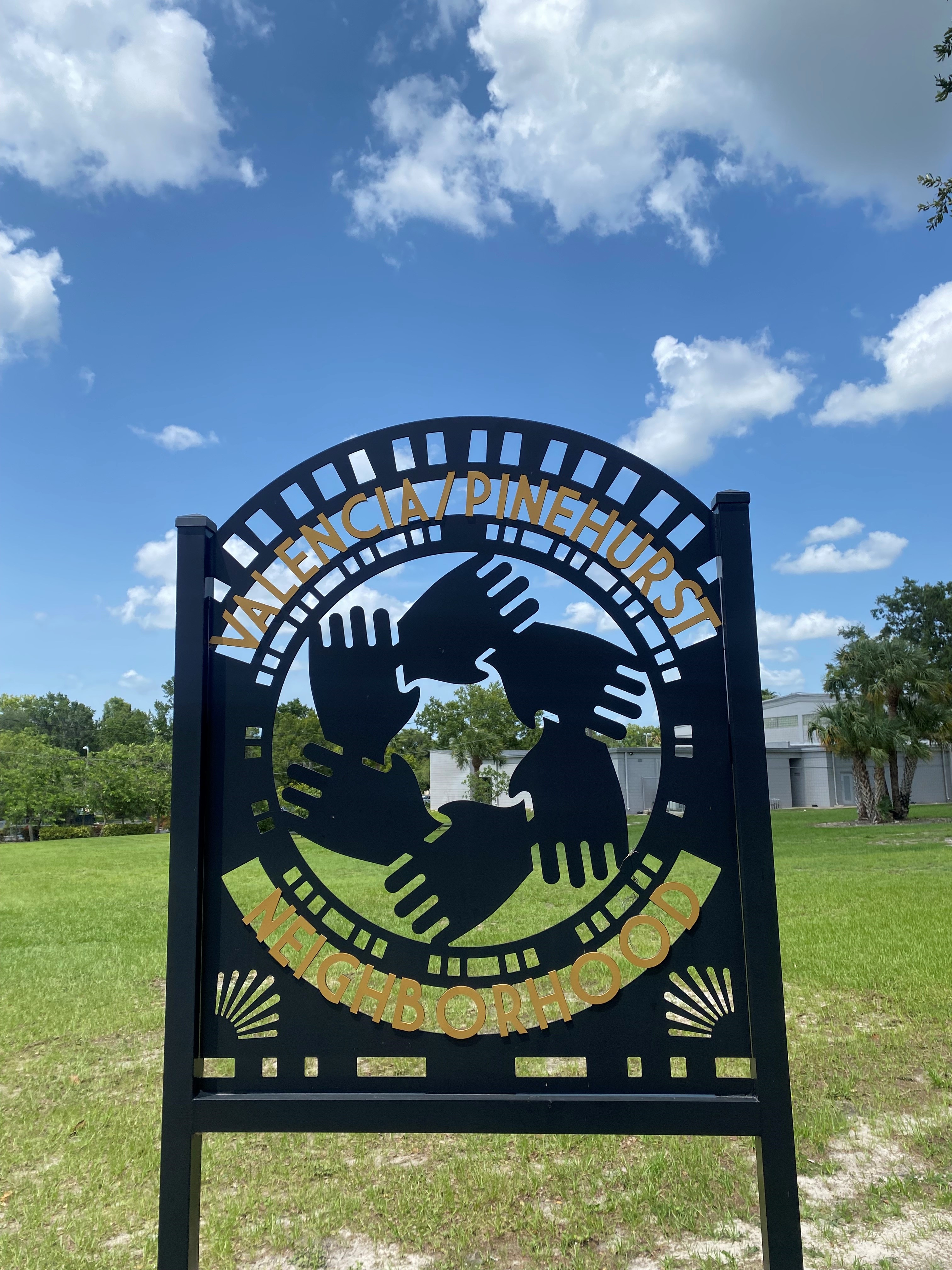 The sign for the Valencia/Pinehurst Neighborhood in front of Simpson Park.