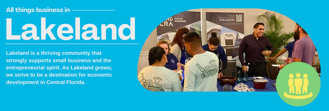 "a blue rectangle with a photo of people at an event. There is white text that states &quot;All things business in lakeland&quot; and then has a another set of text that states &quot;Lakeland is a thriving community that strongly supports small business and the entrepreneurial spirit. As Lakeland grows, we strive to be a destination for economic development in central florida.&quot;