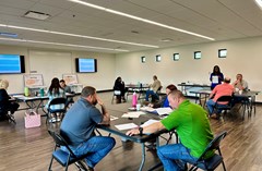 Lake Crago Classroom - set with tables and chairs as attendees work in groups.