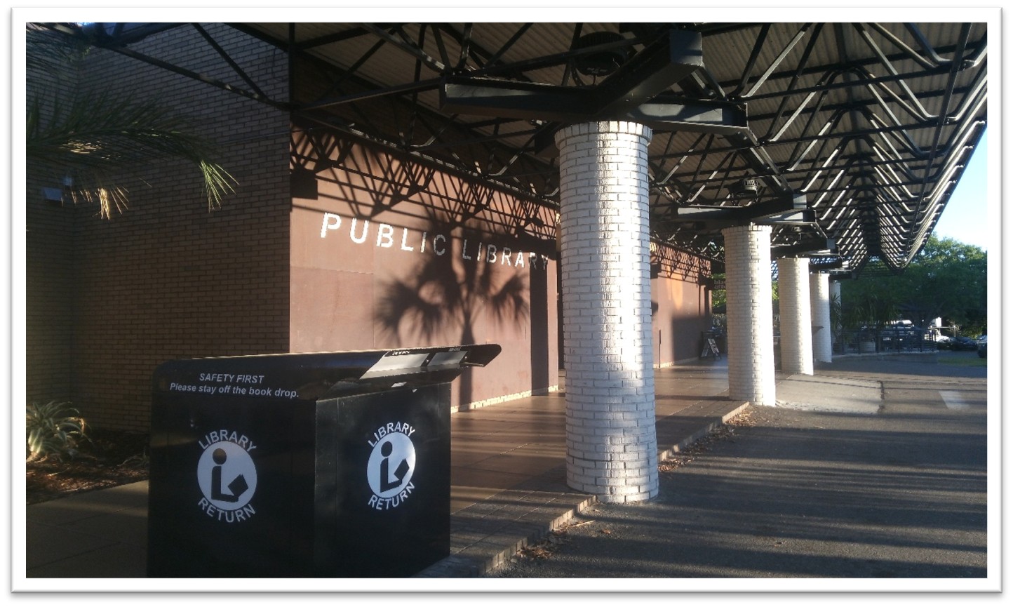 Front entrance to Lakeland Public Library with view of outside bookdrop, white columned walkway, and ramp entrance from parking lot