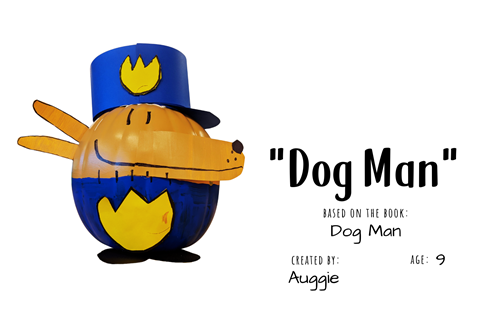 Craft pumpkin decorated to look like police dog "Dog Man" with text "Dog Man, based on the book Dog Man; Created by: Auggie, Age 9"