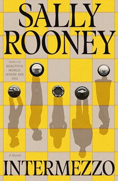 Book cover of Intermezzo by Sally Rooney. Cover features a yellow and cream chessboard with five chess pieces viewed from above. The chess pieces cast a shadow on the board in silhouettes of people.