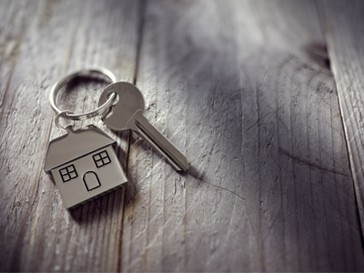 A set of keys with a small house keychain.