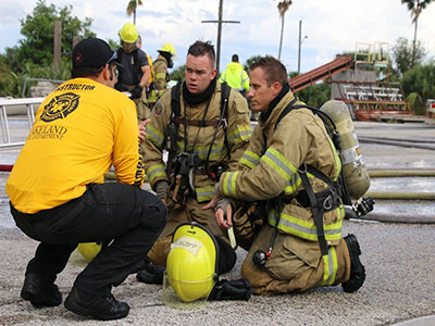 A picture of an instructor with new firefighters