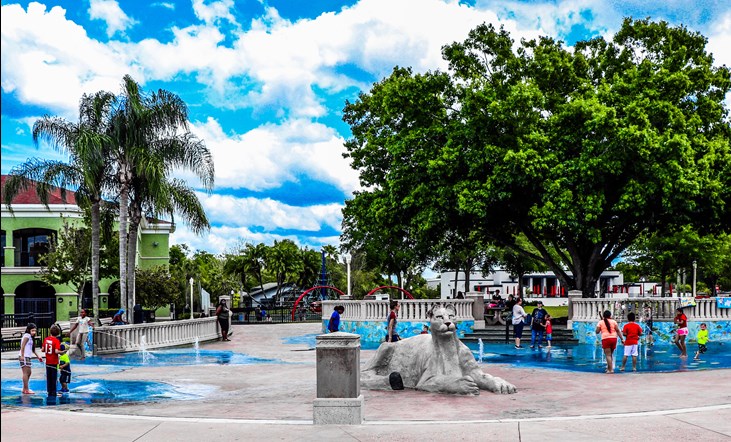 Barnett Family Park with panther sculpture in the middle. Children playing in water.